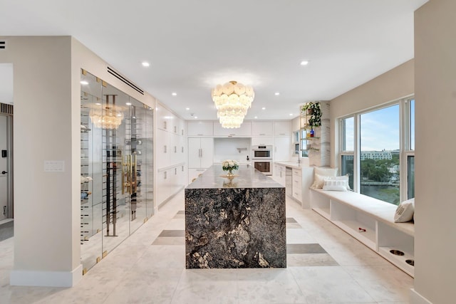 wine cellar featuring sink and an inviting chandelier