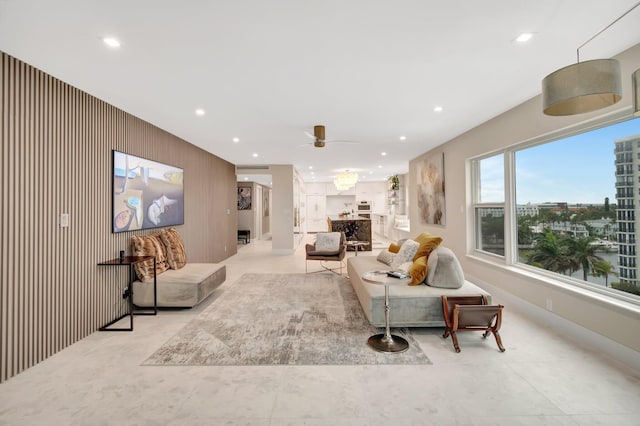 living room featuring wooden walls and ceiling fan