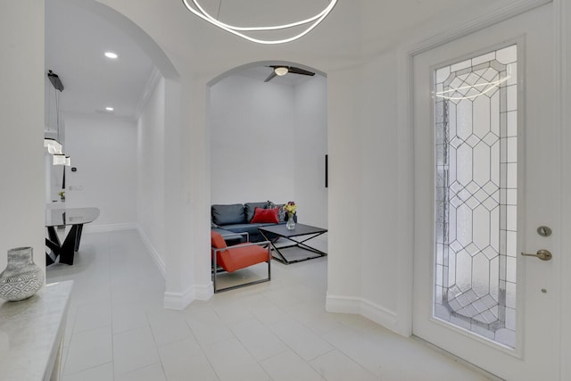 entrance foyer featuring arched walkways, recessed lighting, and baseboards