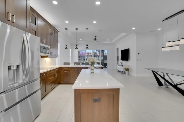 kitchen with a kitchen island, recessed lighting, a sink, light countertops, and appliances with stainless steel finishes