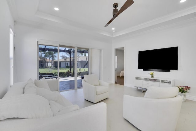 living room featuring ceiling fan, baseboards, ornamental molding, and recessed lighting