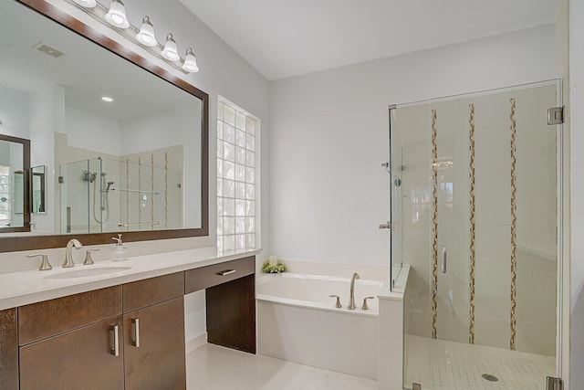 bathroom featuring visible vents, a shower stall, vanity, and a garden tub