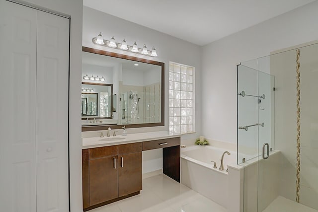 bathroom featuring a bath, tile patterned floors, a stall shower, and vanity