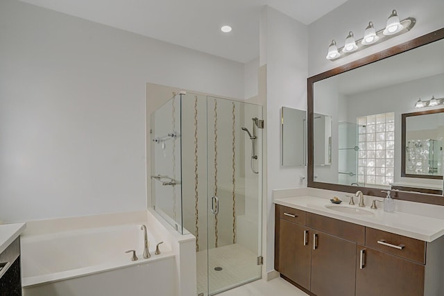 full bathroom featuring a marble finish shower, a garden tub, and vanity