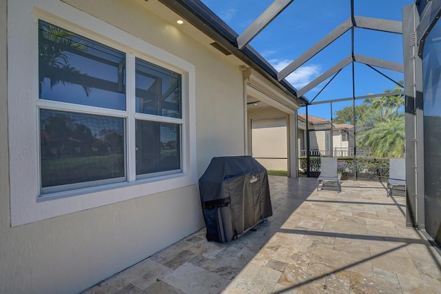 view of patio featuring grilling area and glass enclosure