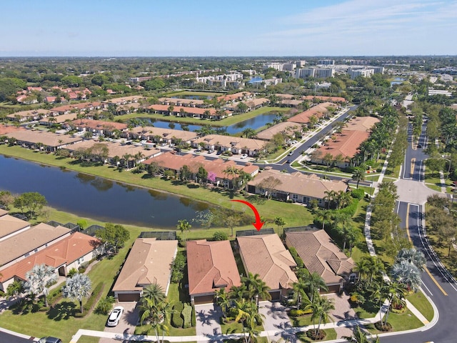 drone / aerial view featuring a residential view and a water view