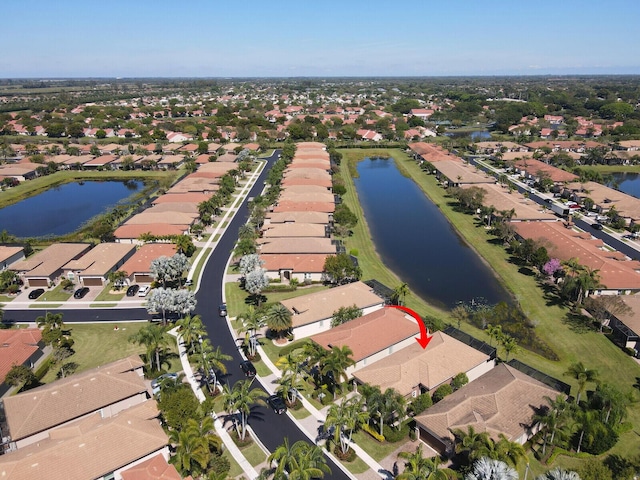 birds eye view of property featuring a water view and a residential view