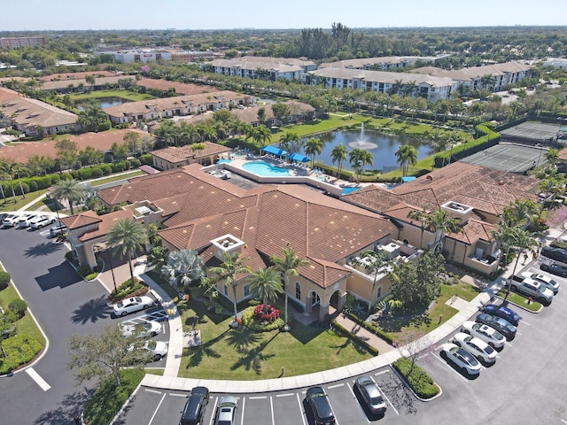 drone / aerial view featuring a residential view and a water view