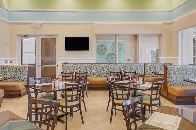 dining room featuring tile patterned floors, a high ceiling, and visible vents