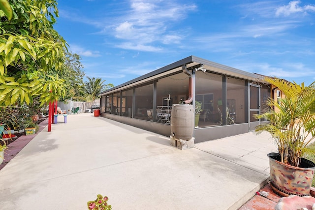 exterior space with a patio and a sunroom