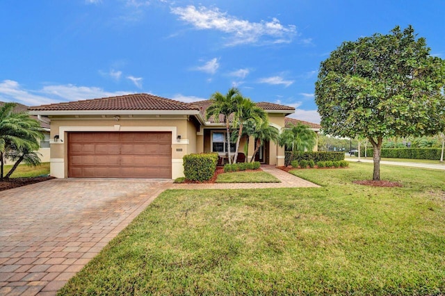 mediterranean / spanish home featuring a front lawn and a garage