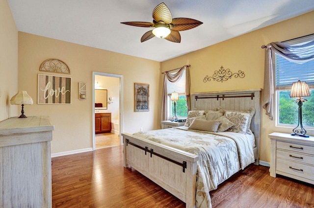 bedroom featuring dark wood-type flooring, ceiling fan, and connected bathroom