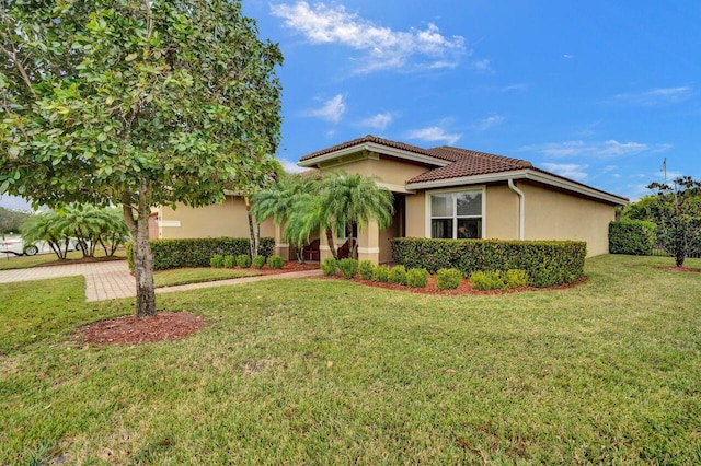 mediterranean / spanish-style home with a front yard