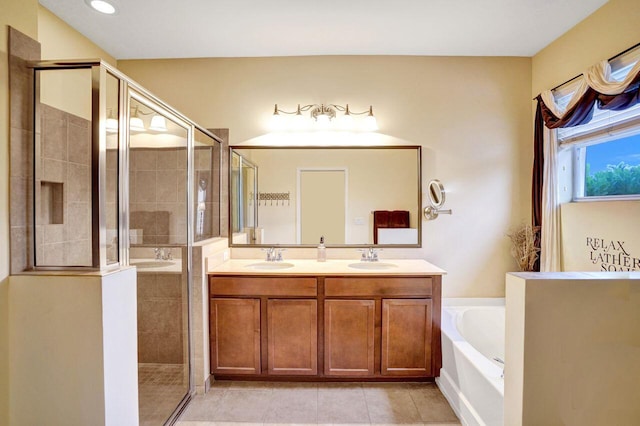 bathroom with tile patterned floors, vanity, and independent shower and bath