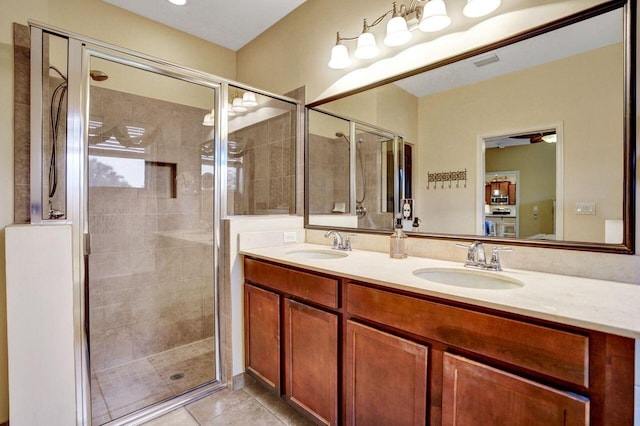 bathroom featuring tile patterned flooring, walk in shower, and vanity