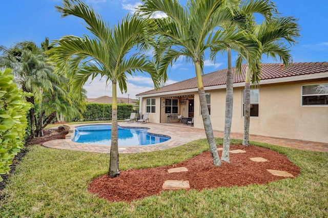 view of pool featuring a patio area and a lawn