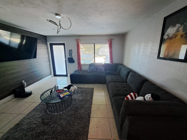 tiled living room featuring a textured ceiling