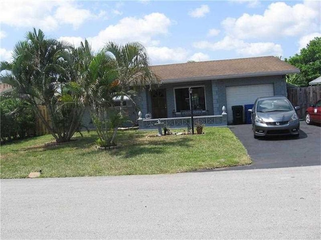 ranch-style home featuring a garage and a front yard