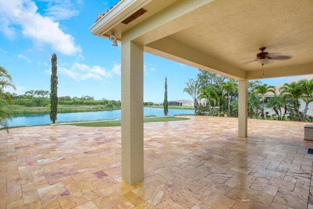 view of patio / terrace with ceiling fan and a water view