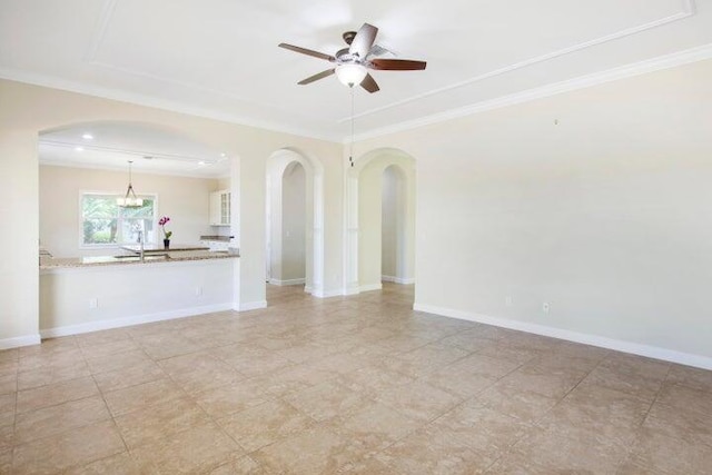 unfurnished room with sink, ceiling fan, and ornamental molding