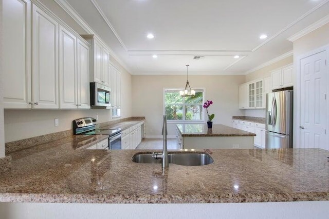 kitchen featuring sink, white cabinets, kitchen peninsula, and appliances with stainless steel finishes