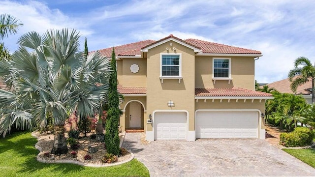 mediterranean / spanish house with a garage