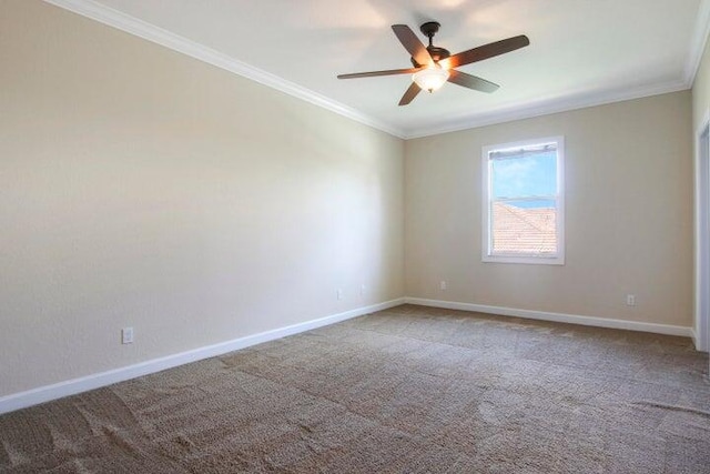 carpeted empty room with ceiling fan and crown molding