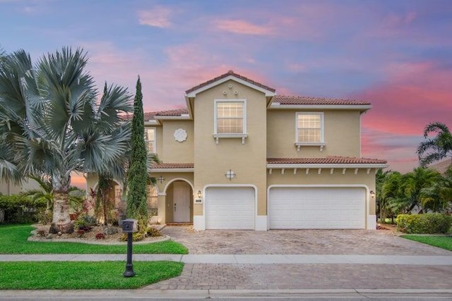 mediterranean / spanish home featuring a garage