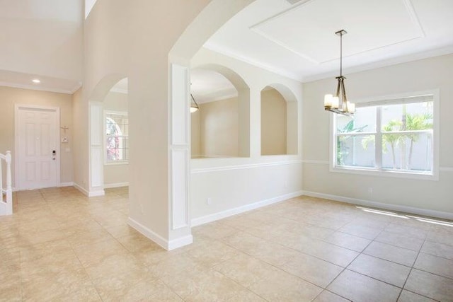 unfurnished room with a notable chandelier, ornamental molding, and light tile patterned flooring