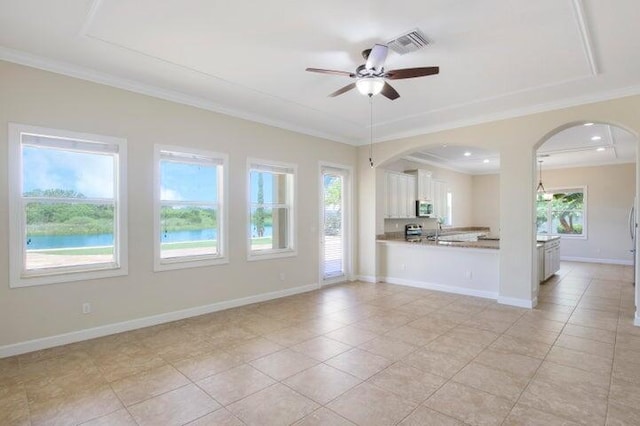 unfurnished living room featuring crown molding, light tile patterned flooring, and ceiling fan