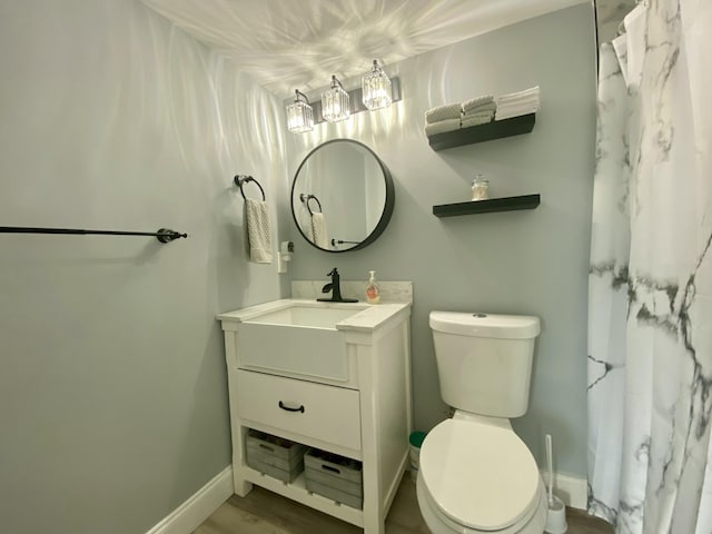 bathroom featuring hardwood / wood-style floors, toilet, and vanity