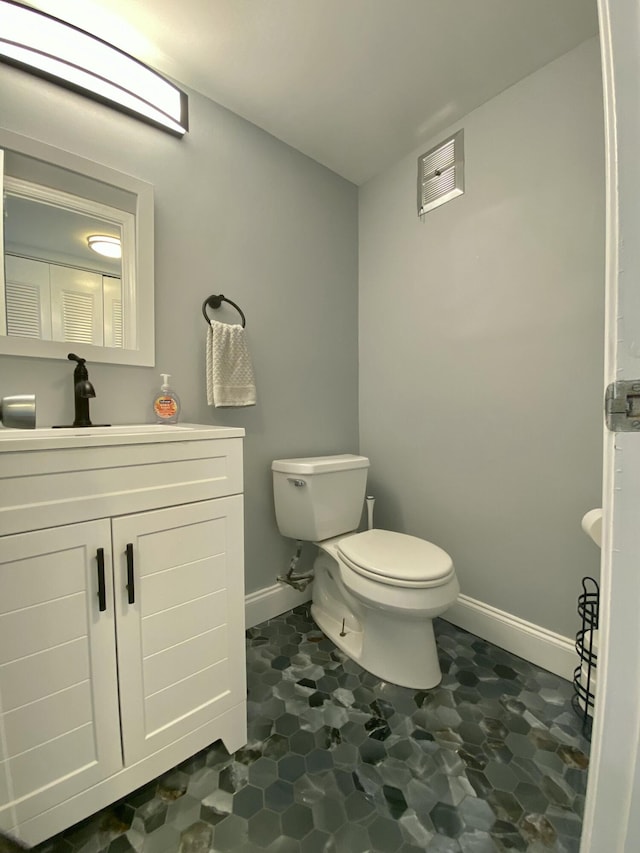 bathroom with toilet and vanity