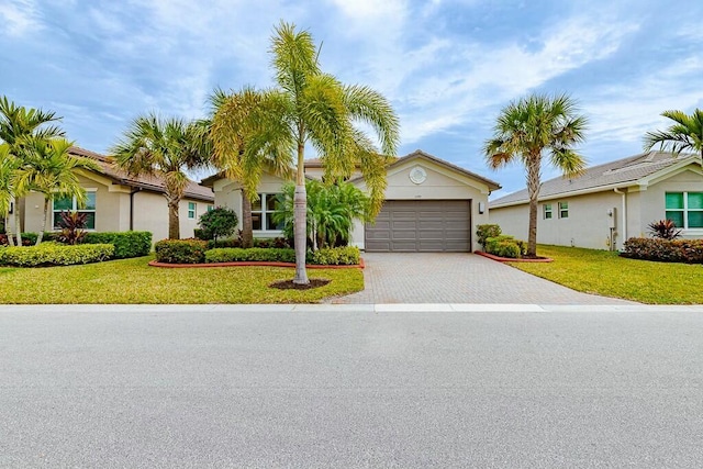 view of front facade with a front yard and a garage