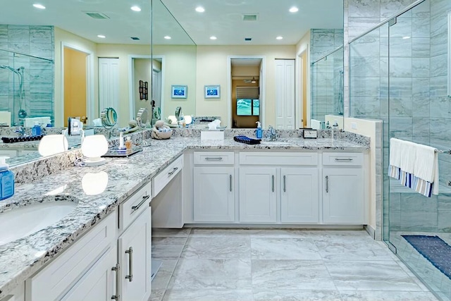 bathroom featuring vanity and a shower with door