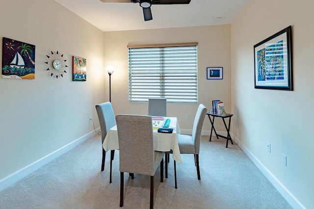 dining area featuring light colored carpet and ceiling fan