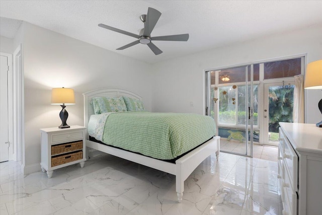 bedroom featuring ceiling fan, access to outside, french doors, and a textured ceiling