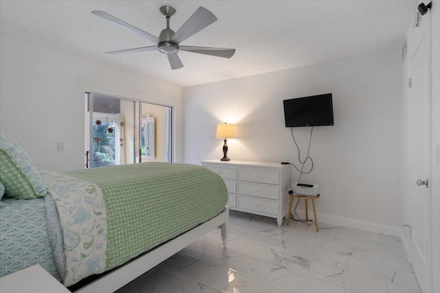 bedroom featuring ceiling fan, a closet, and a textured ceiling