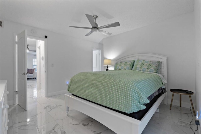 bedroom with a textured ceiling and ceiling fan