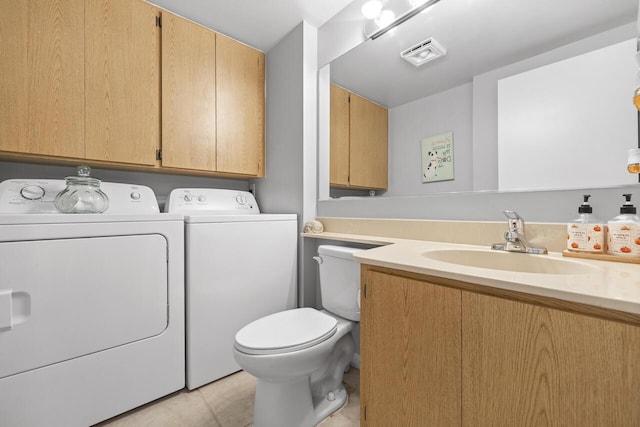 bathroom featuring separate washer and dryer, toilet, sink, and tile patterned flooring