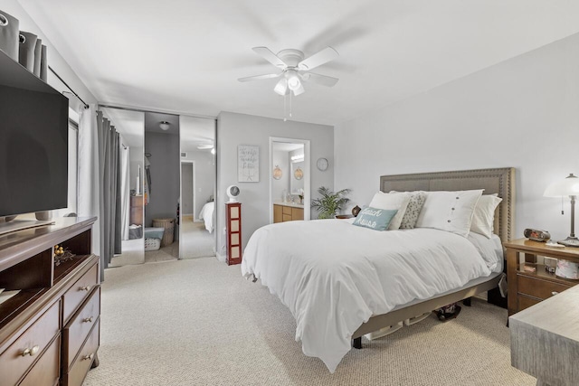 carpeted bedroom with ceiling fan and connected bathroom