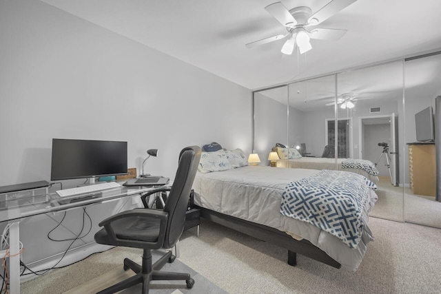 carpeted bedroom with ceiling fan and a closet