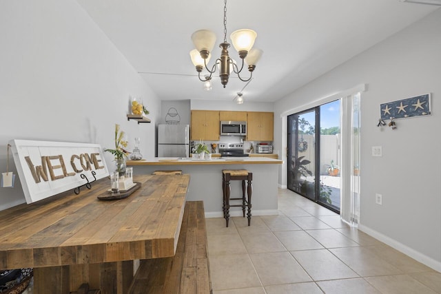 tiled dining room featuring a notable chandelier