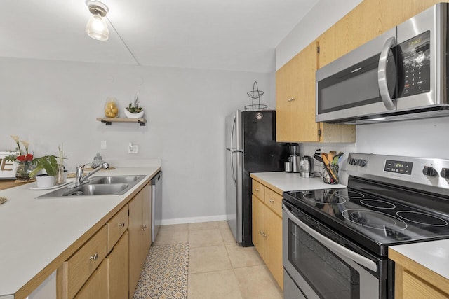 kitchen with light tile patterned floors, light brown cabinetry, sink, and stainless steel appliances