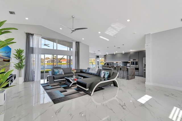 living room with a water view, ceiling fan, and lofted ceiling