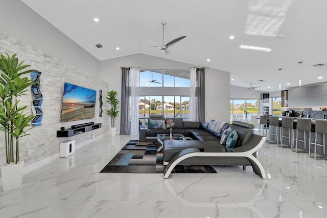 living room featuring ceiling fan and high vaulted ceiling