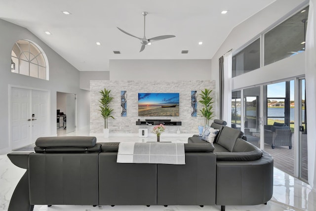 living room featuring ceiling fan and high vaulted ceiling