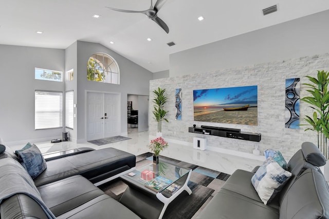 living room featuring ceiling fan and high vaulted ceiling