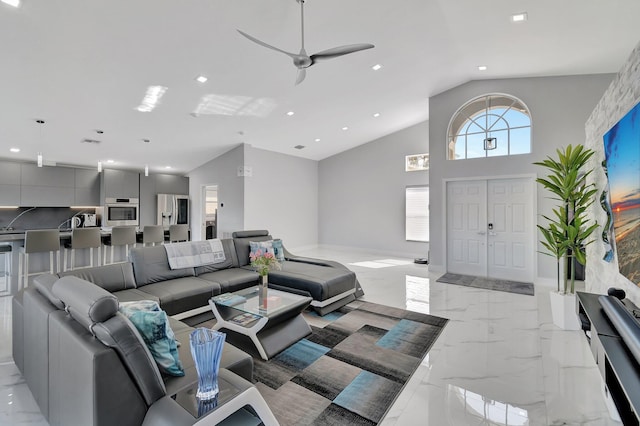 living room with ceiling fan and high vaulted ceiling