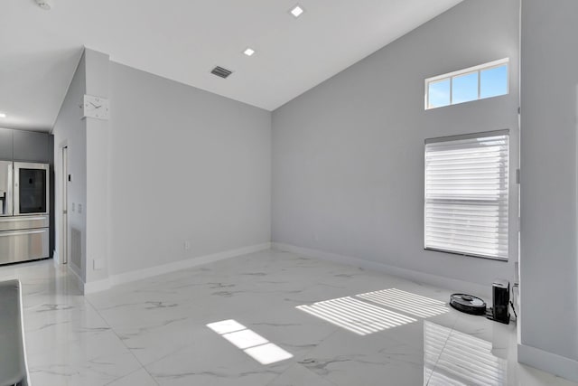 empty room featuring high vaulted ceiling