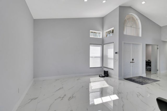 entryway featuring high vaulted ceiling